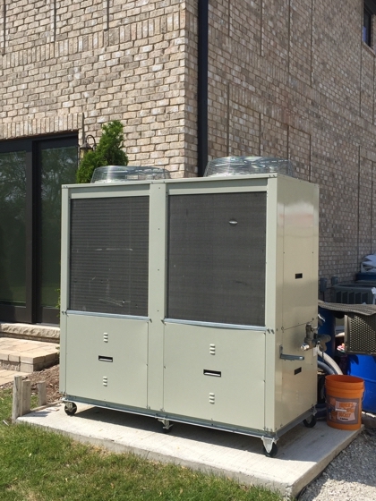 Back view of an ice rink chiller for a residential portable refrigerated outdoor ice hockey rink in Elmhurst, Illinois