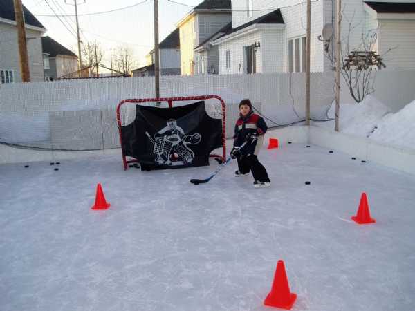 My son and friend playing backyard hockey on my backyard ice rink.