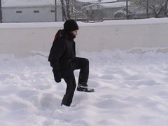 Stomping on Snow to Pack for Backyard Ice Rink