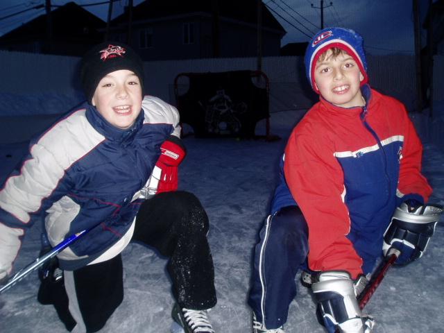 My son and friend playing backyard hockey on my first backyard ice rink.